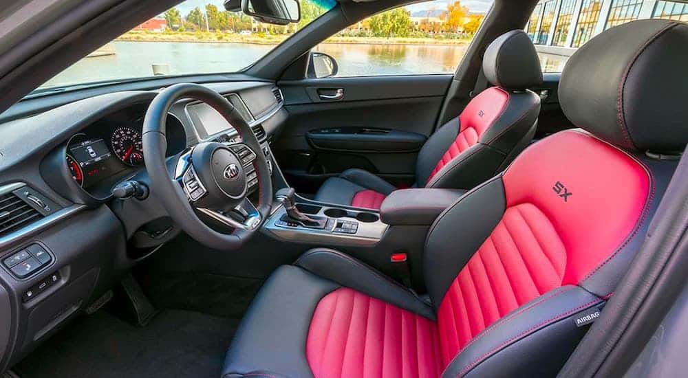 A red and black interior of a 2020 Kia Optima SX is shown from the side.