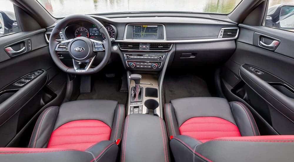 The black and red interior of a 2020 Kia Optima is shown.