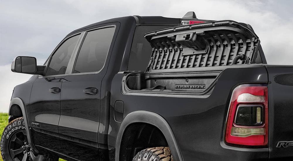 The Rambox bed storage is open on a black 2020 Ram 1500.