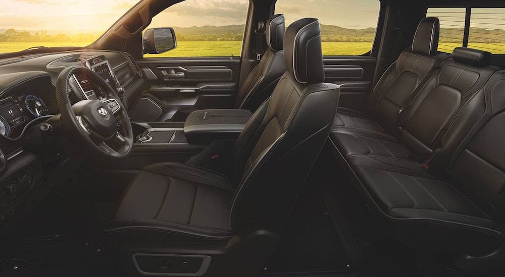 The two rows of seats inside a 2020 Ram 1500 are shown from the side.