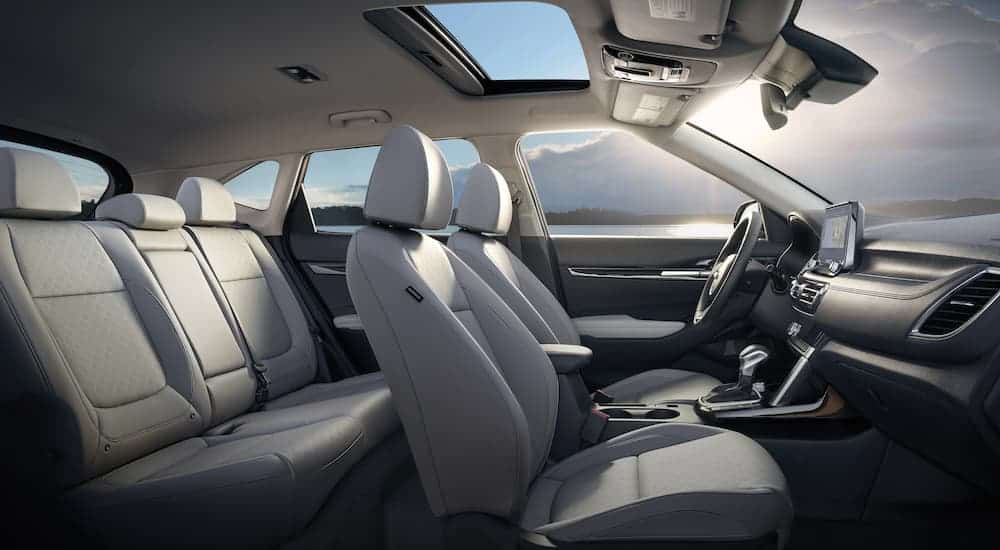 The white interior of a 2021 Kia Seltos is shown from the side.
