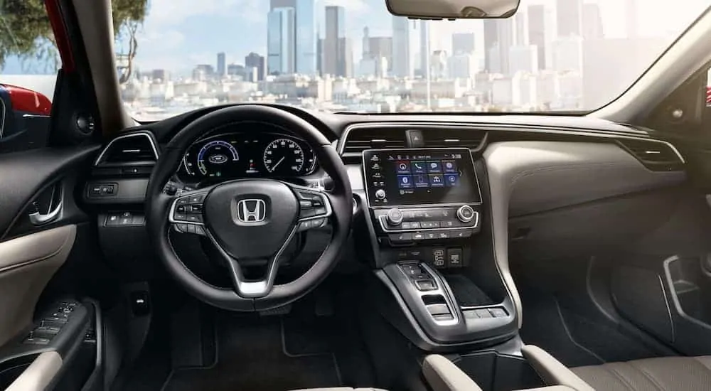 The interior of a 2021 Honda Insight is shown with a city in the windshield.