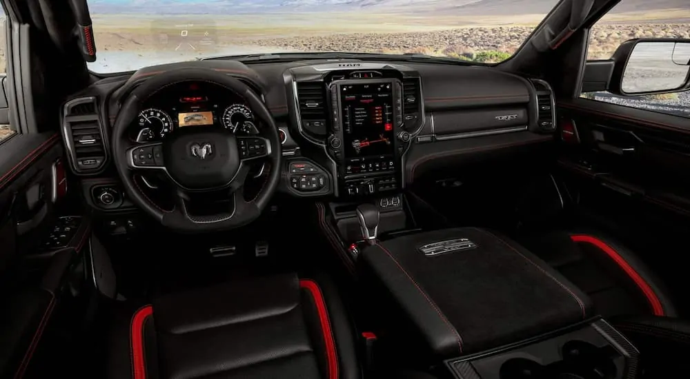 The black and red interior of a 2021 Ram 1500 TRX is shown.