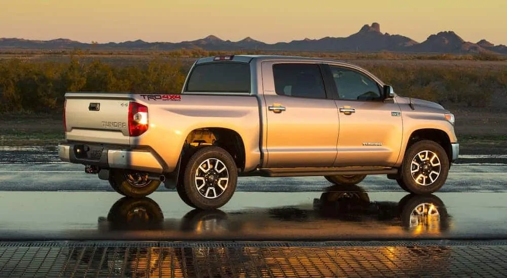 A silver 2017 Toyota Tundra TRD is facing distant mountains at sunset.