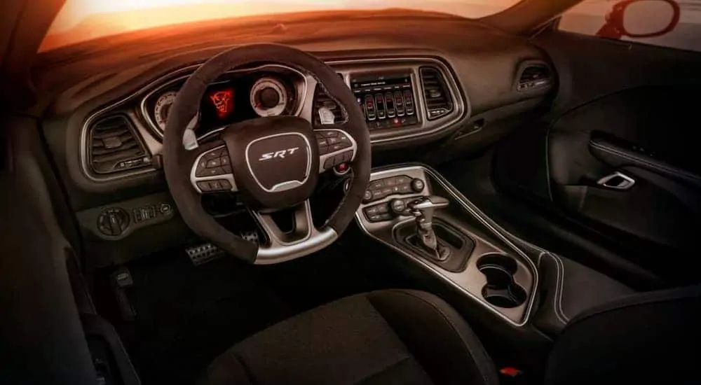 The black interior of a 2018 Dodge Challenger is shown.