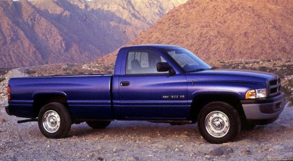 A blue 1994 Ram 1500 from a Ram dealer near you is parked in front of mountains.