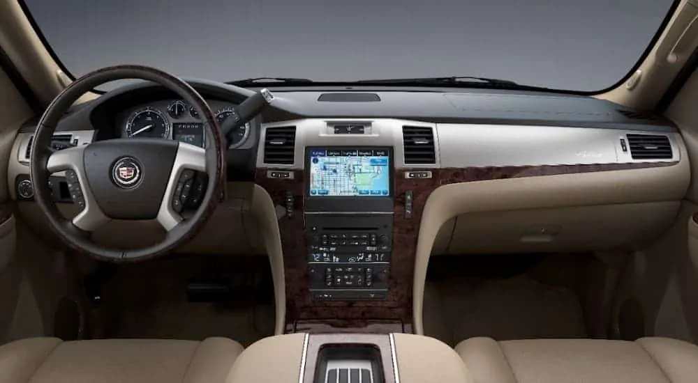 The black and tan interior is shown on a 2014 used Cadillac Escalade.