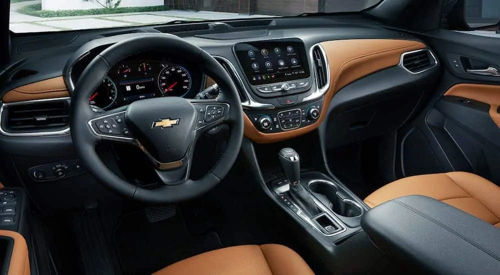The tan and black interior of a 2020 Chevy Equinox is shown.