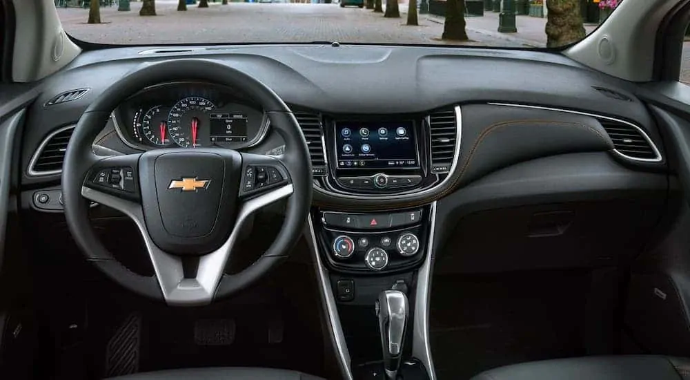 The black interior with orange stitching is shown in a 2020 Chevy Trax.