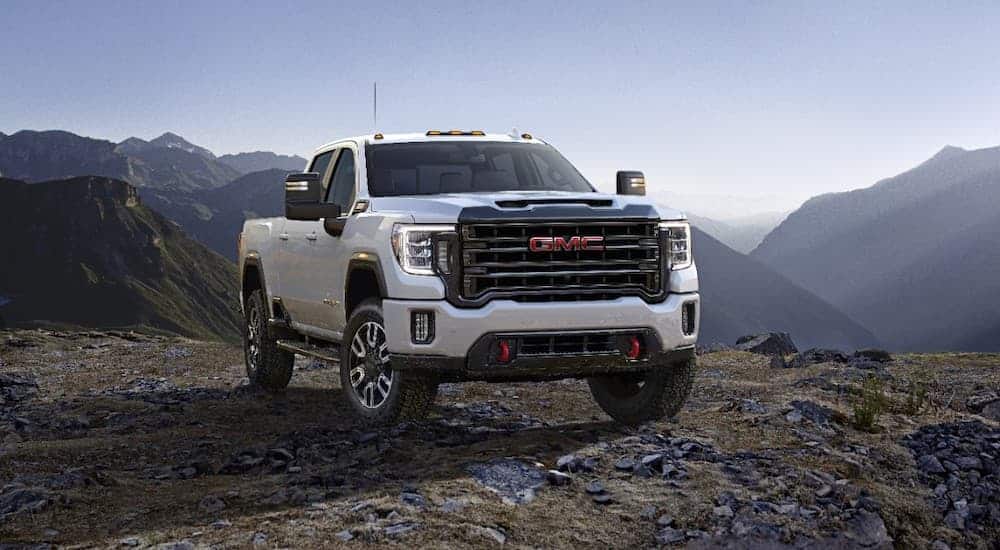 A white 2020 GMC Sierra 2500HD AT4 is parked in the mountains.