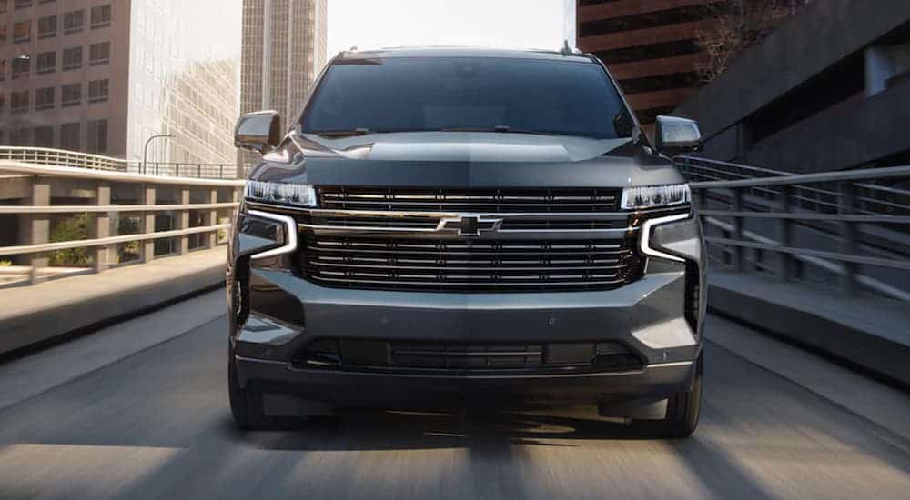 A black 2021 Chevy Tahoe RST is shown from the front driving down an off-ramp.