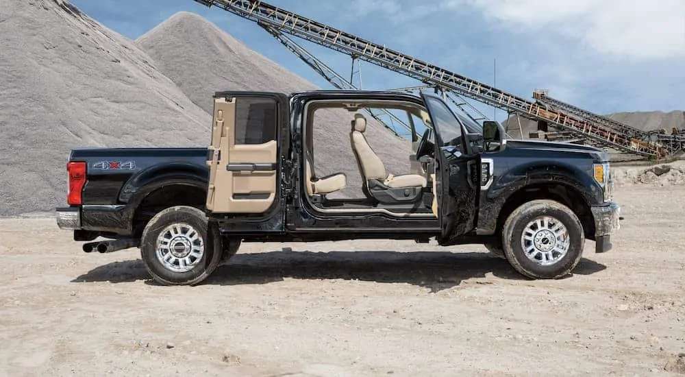 The doors are open on a 2018 Ford F-250, which is shown from the side at a sane pit.