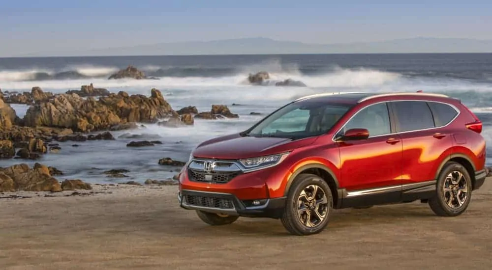 A red 2017 used Honda CRV is parked near the ocean.