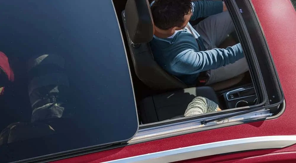 A red 2020 Chevy Equinox is shown from above with the sunroof open.