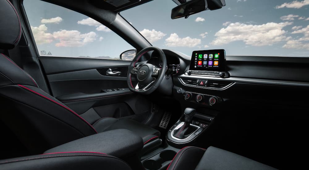 The black and red interior of a 2021 Kia Forte is shown.