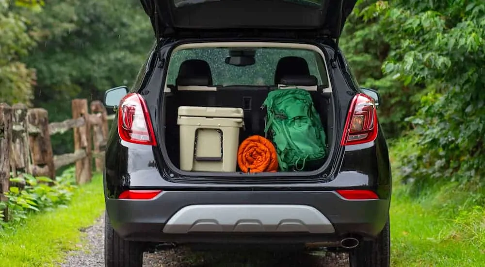 A black 2021 Buick Encore is shown from the rear with its hatch open.