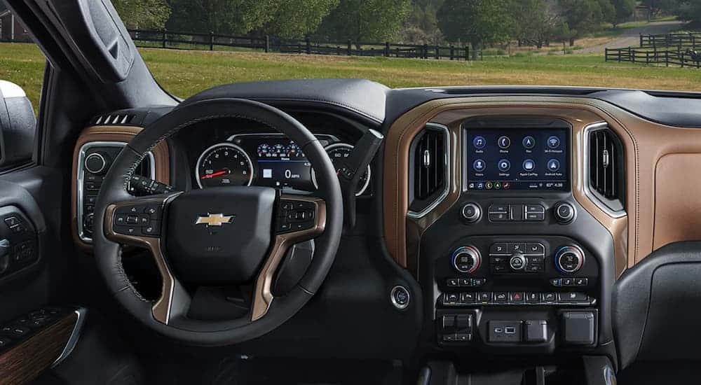 The wheel and infotainment screen are shown in a 2021 Chevy Silverado 1500.
