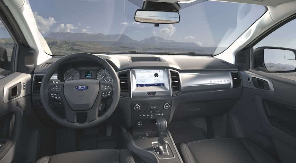 The black interior on a 2021 Ford Ranger SE is overlooking mountains.