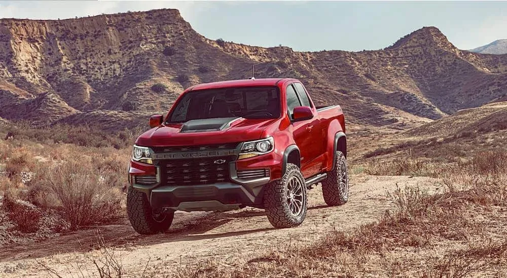 A red and black 2021 Chevy Colorado ZR2 is parked in the desert.