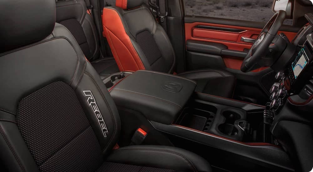 The red and black interior is shown on a 2021 Ram 1500 Rebel.