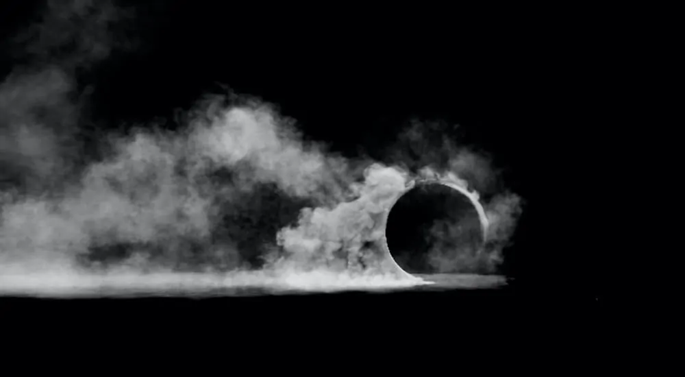 A tire is spinning and leaving a trail of smoke.