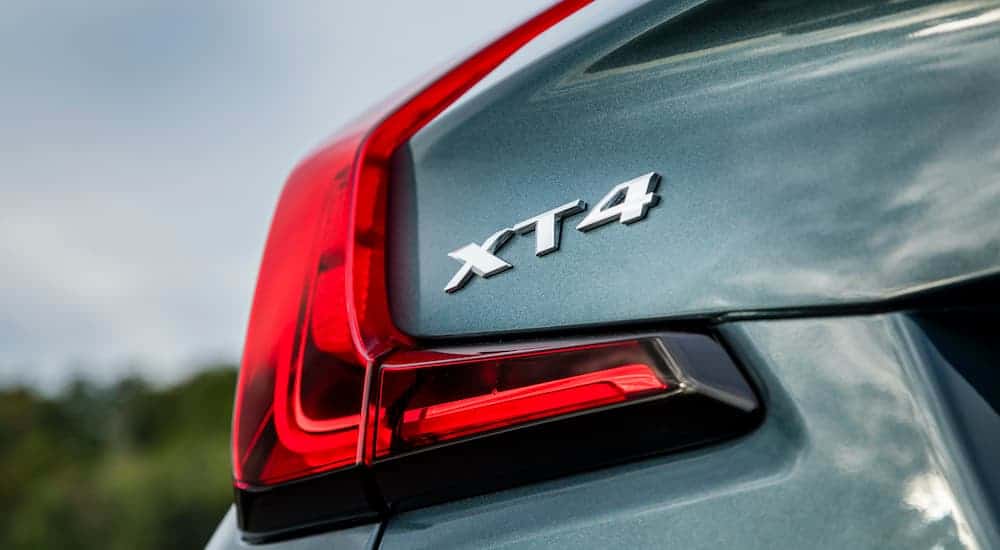 A close up of the rear XT4 badge is shown on a blue 2019 Cadillac XT4.