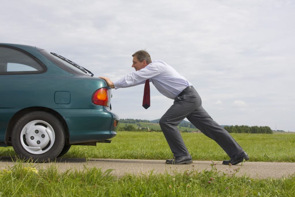 Man Pushing His Car