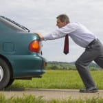 Man Pushing His Car