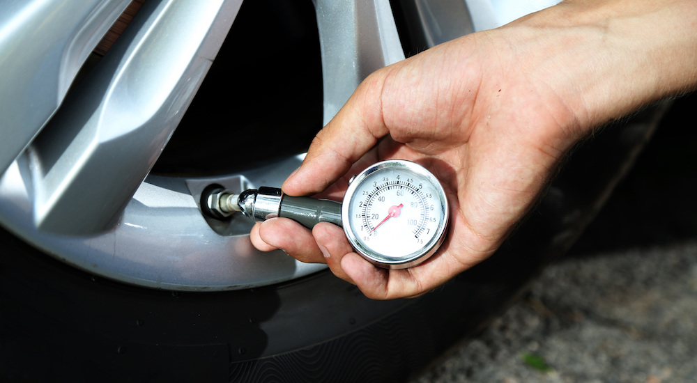 Tire Pressure being checked with gauge
