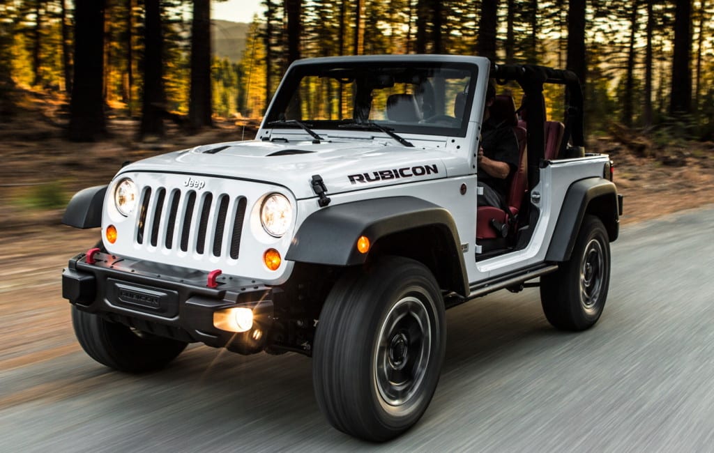 A white 2013 Jeep Wrangler Rubicon is driving.