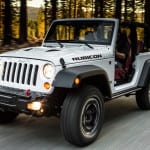 A white 2013 Jeep Wrangler Rubicon is driving.