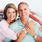 An older couple excited over their new car