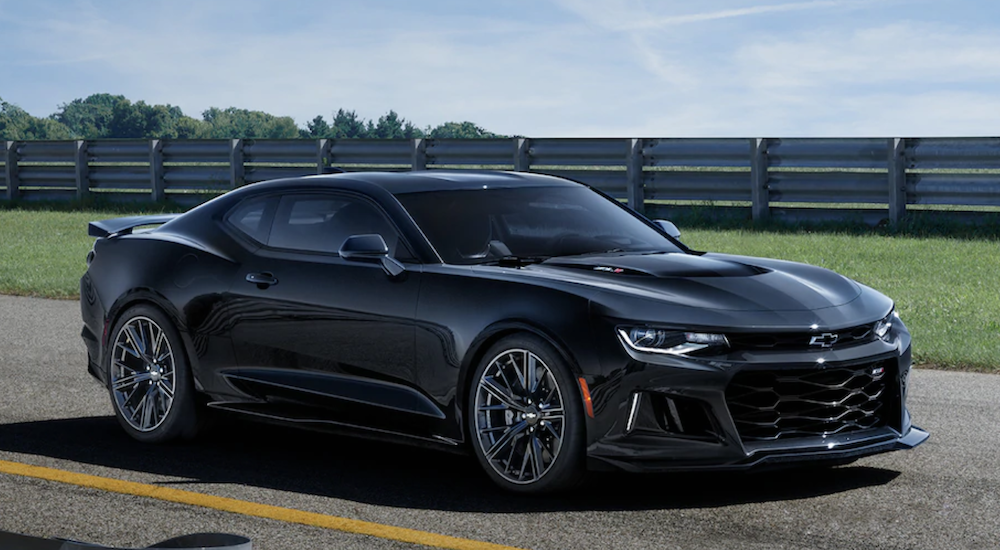 A black 2019 Chevrolet Camaro ZL1 is shown on a track.