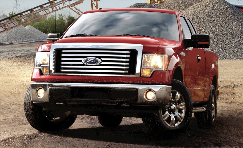 A 2011 Red Ford F-150 from the front in a gravel pit