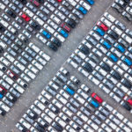 Aerial view of a jam-packed parking lot at a buy here, pay here dealership