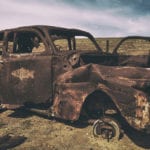 Rusty Car in the desert at midday