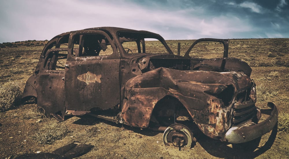 Rusty Car in the desert at midday