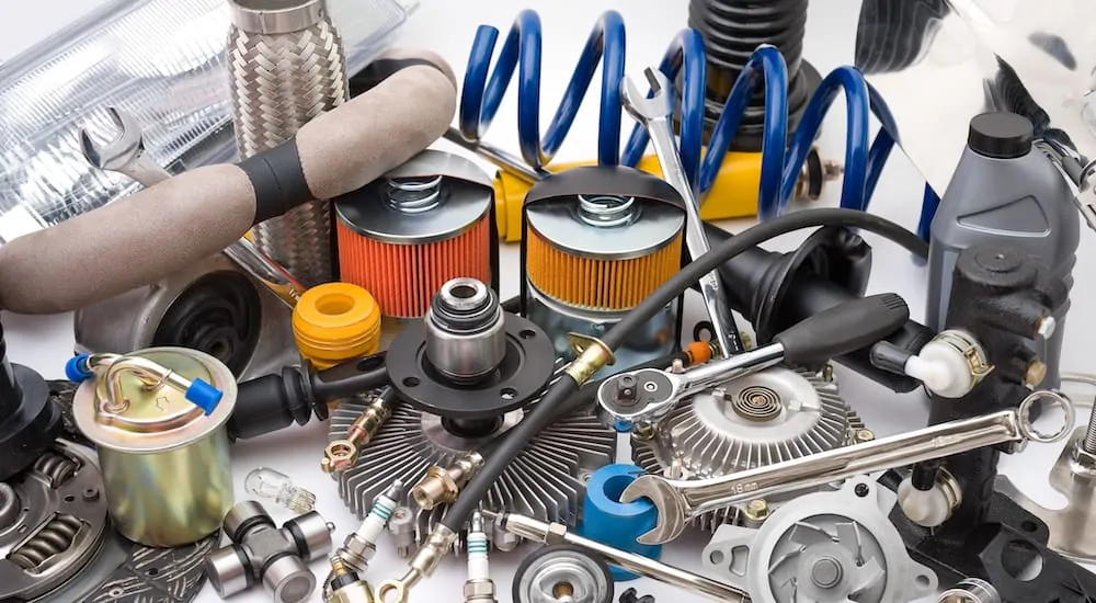 A collection of auto parts on a white background being displayed