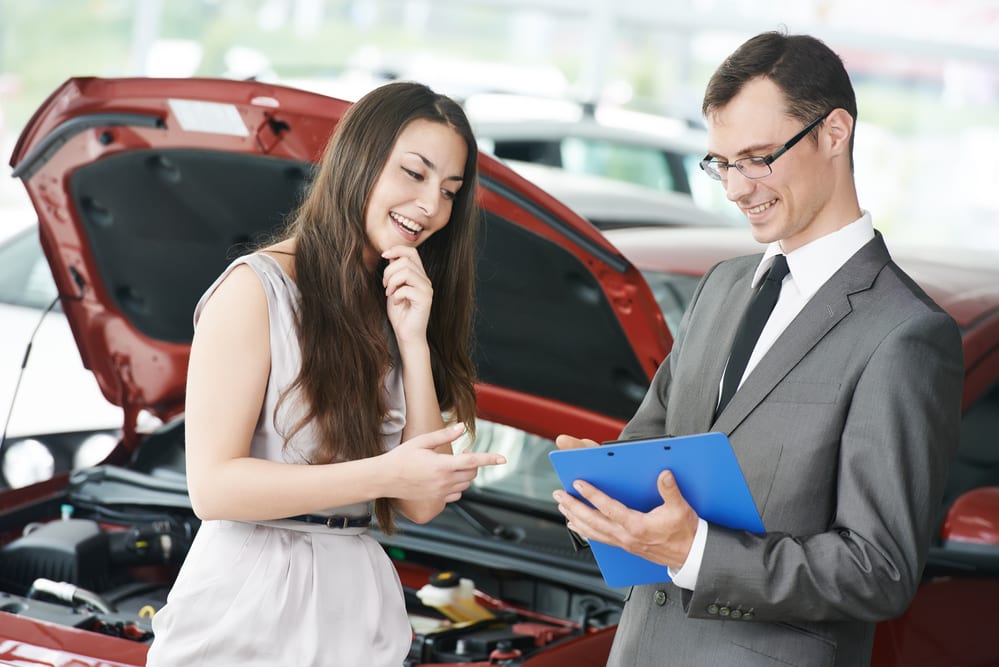 Millennial Buying Used at a Car Dealership with Salesman in Colorado