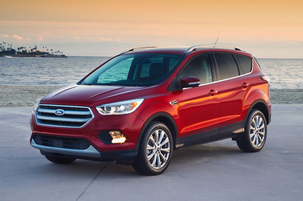A red 2017 Ford Escape on a beach at sunset