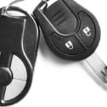 A closeup of car keys on a white background