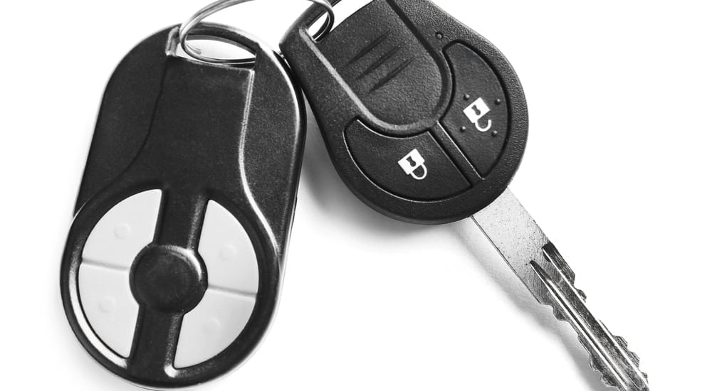 A closeup of car keys on a white background
