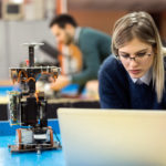 Young woman engineer working on robotics project