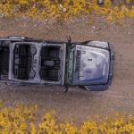 A 2019 Jeep Wrangler is shown from above on a dirt road with the top off.