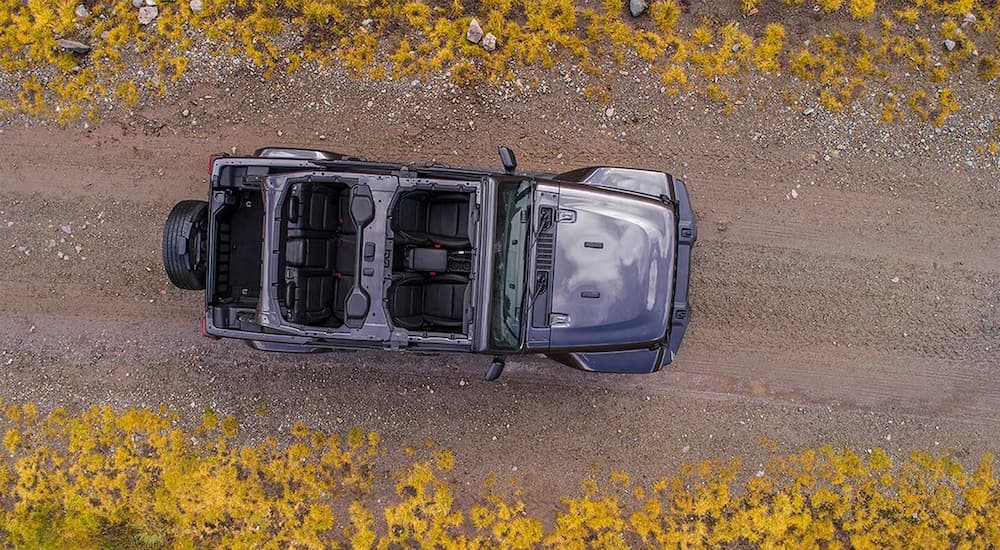 A 2019 Jeep Wrangler is shown from above on a dirt road with the top off.