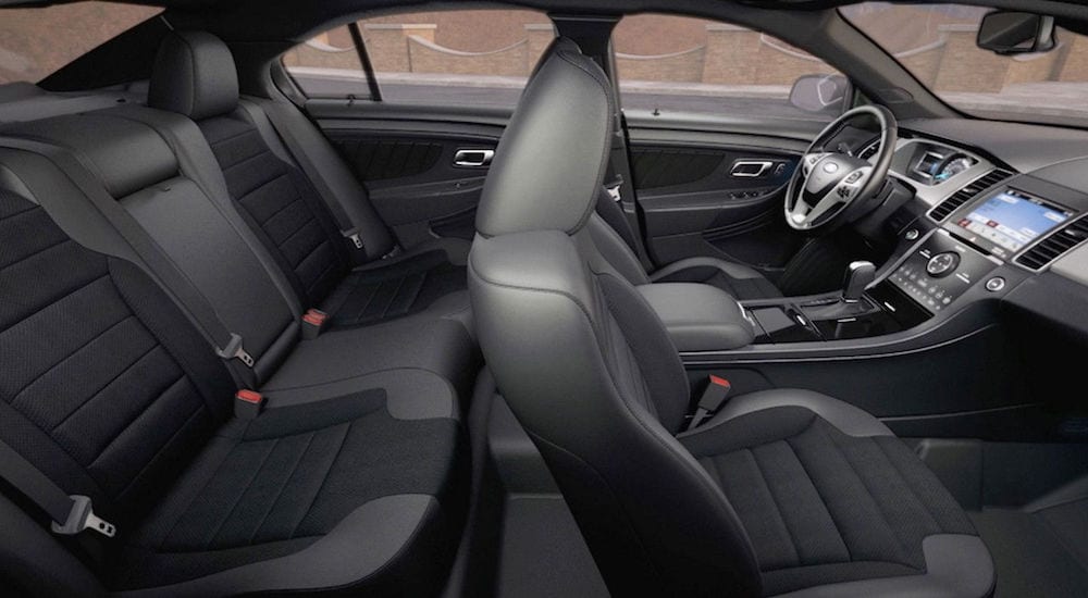 The black interior of a 2018 Ford Taurus is shown from the passenger side.