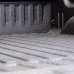 A close up shows a truck bed equipped with a liner.