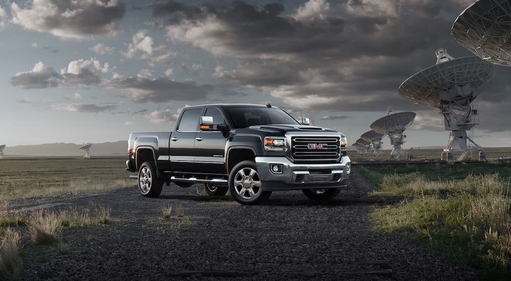 Black 2018 GMC Sierra 2500HD in front of large satellite receivers