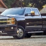 Black 2019 Chevy Silverado 2500HD in front of log cabin