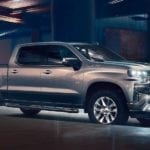 Silver 2019 Chevy Silverado under overpass